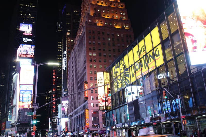 Times Square at night, crowded with people and bright theater and advertising billboards