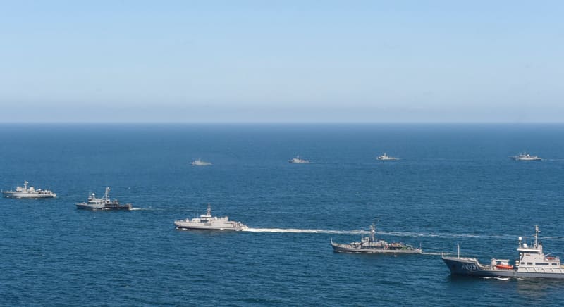 Soldiers and armoured vehicles from several NATO countries during a multinational military exercise